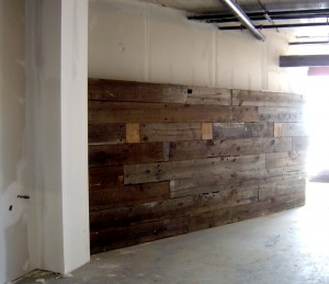 At the main entrance to the classrooms, the wall constructed from the wood taken from the Hawkins' barn